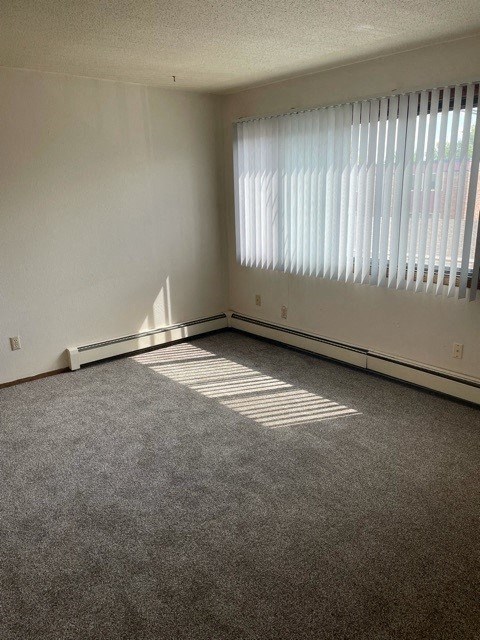 an empty living room with a large window