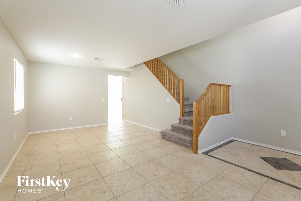 the living room and entryway with stairs to the loft