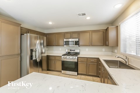 a kitchen with stainless steel appliances and white counter tops