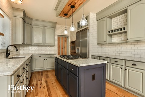 a kitchen with a blue island and white cabinets