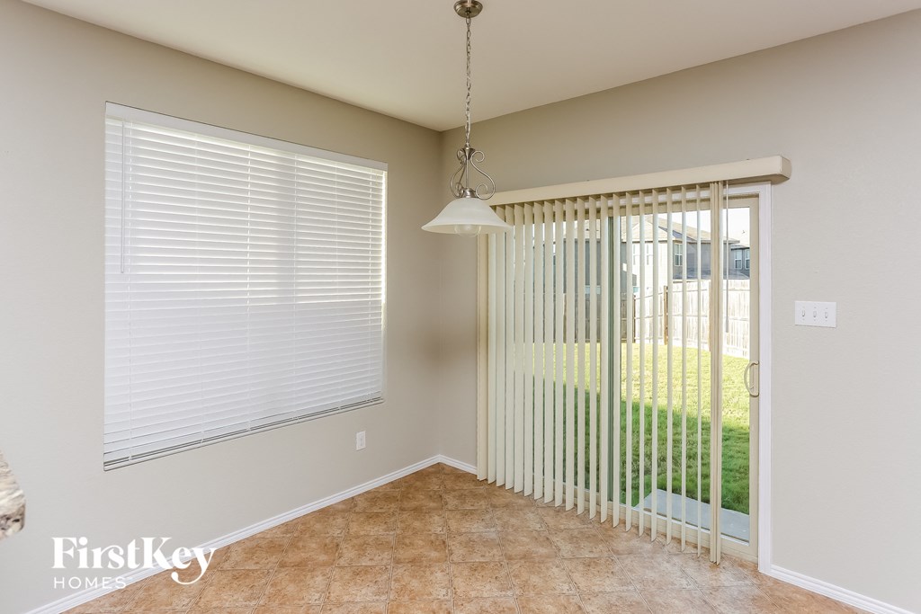 a living room with a large window and a door to the yard
