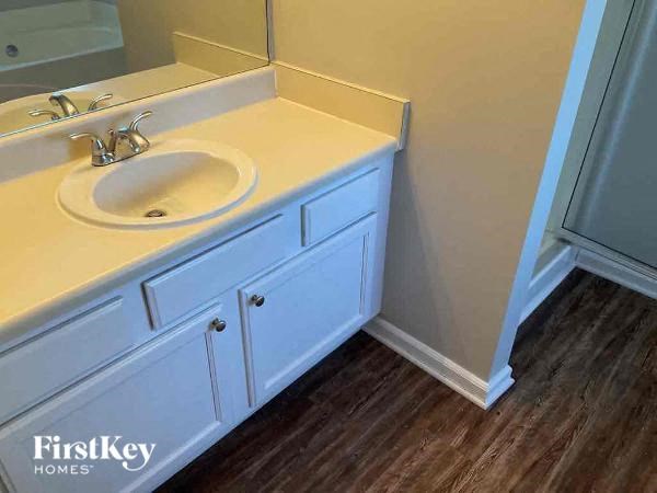 A bathroom with a sink and a mirror.
