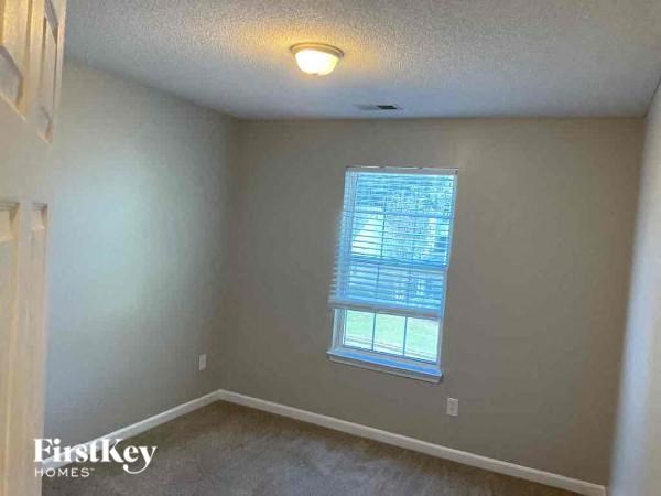 A room with a window and a First Key Homes logo.