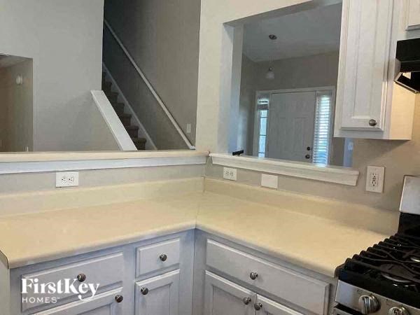 A kitchen with a stove top oven and a counter top.