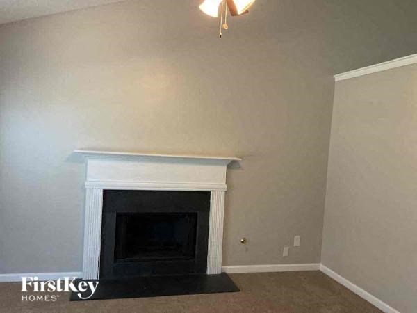 A fireplace in a room with a beige wall.