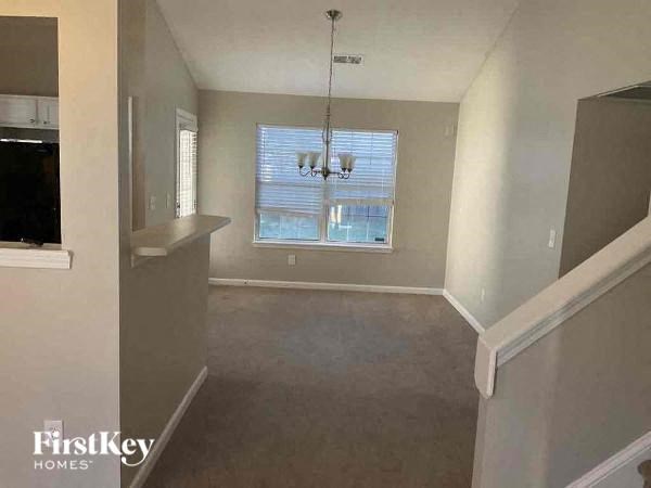 A room with a window and a staircase.