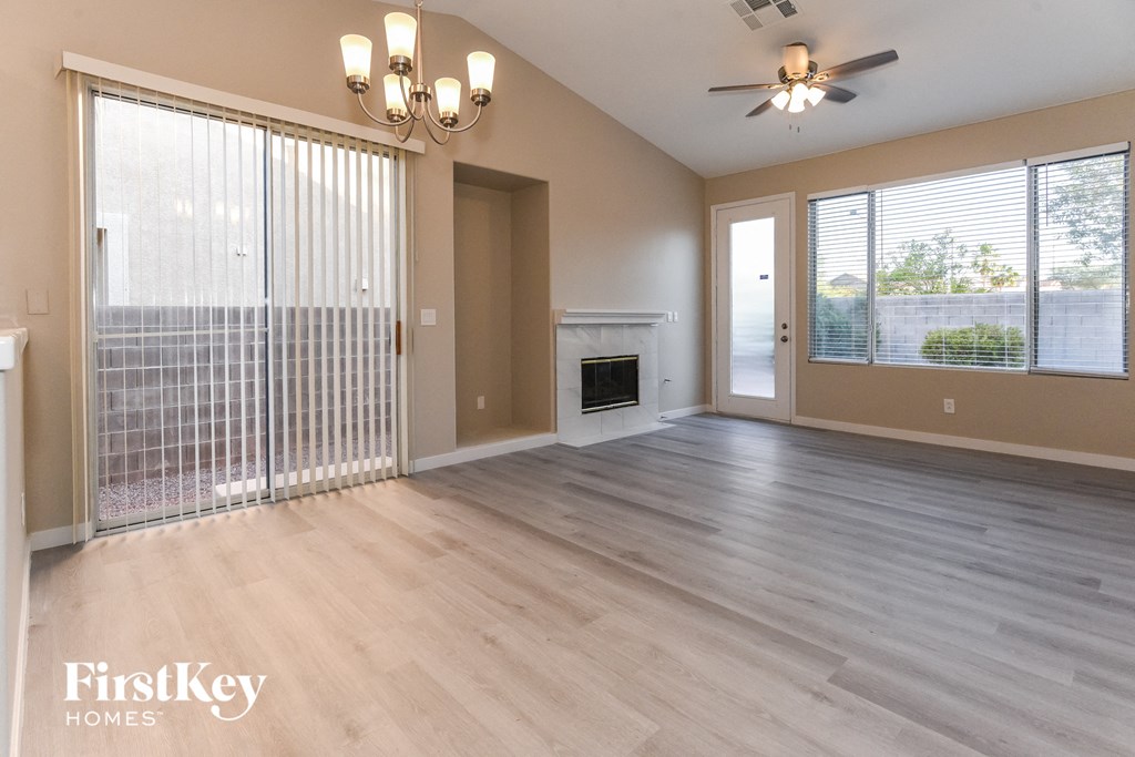 the living room of an empty house with a fireplace