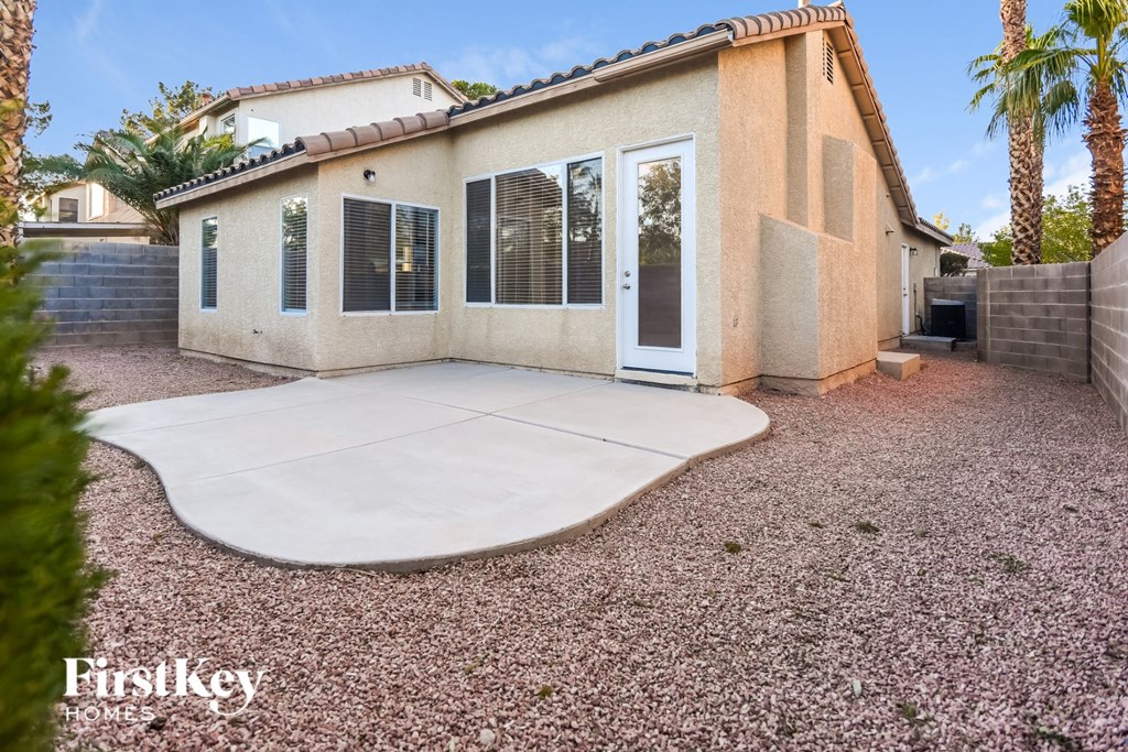 a patio in front of a house with a driveway