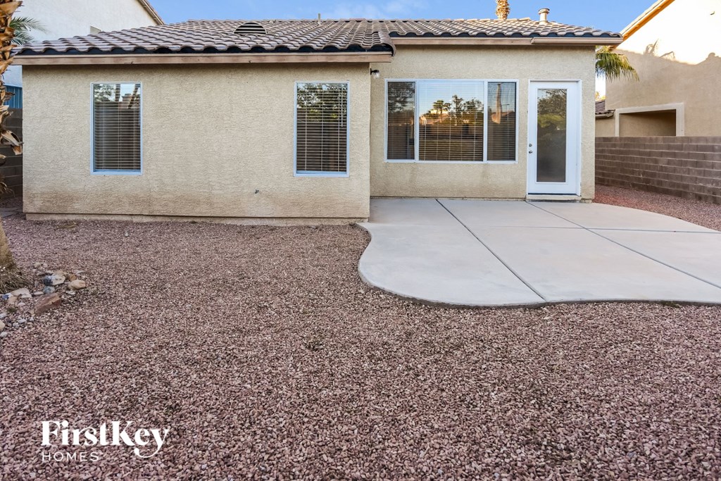 a front yard with a concrete patio and a house