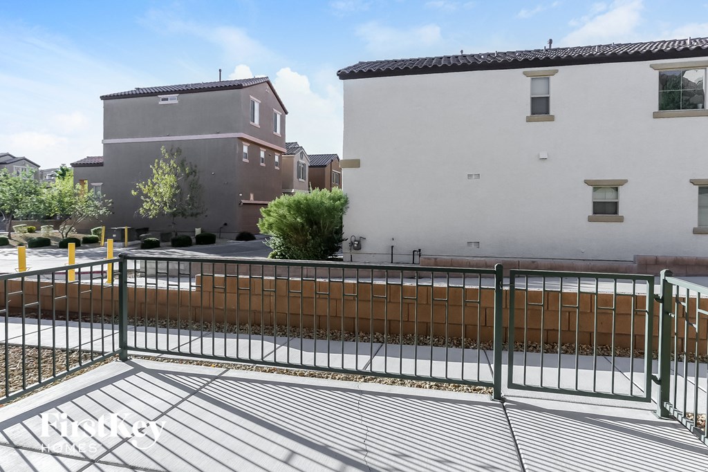an image of a yard with a fence and two buildings