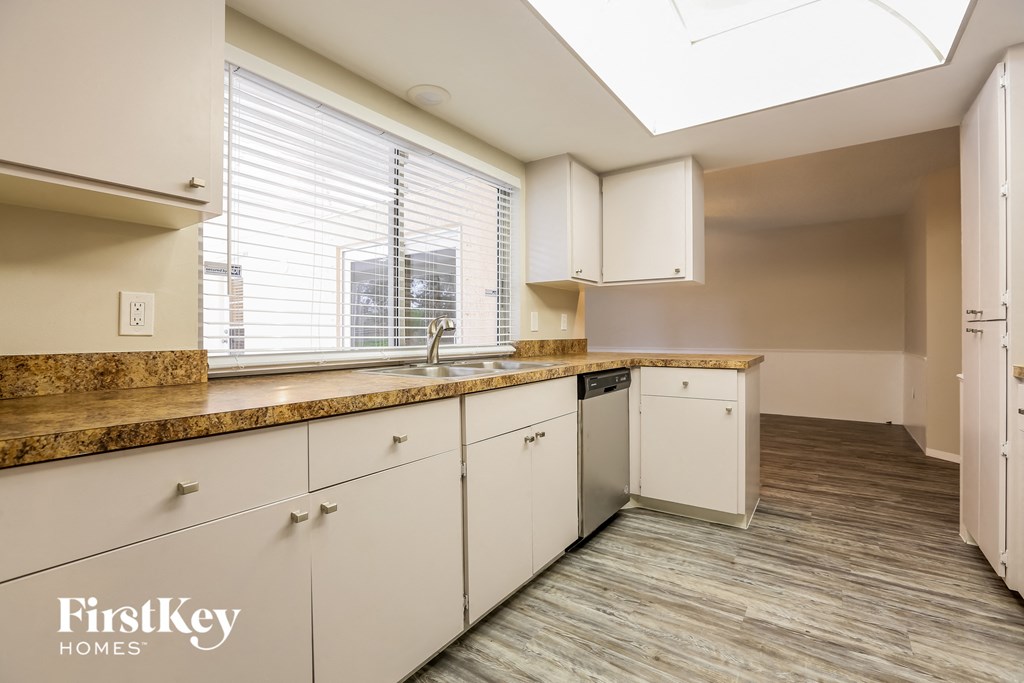 A kitchen with a FirstKey Homes logo.