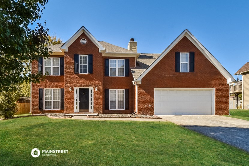 a red brick house with a white garage door