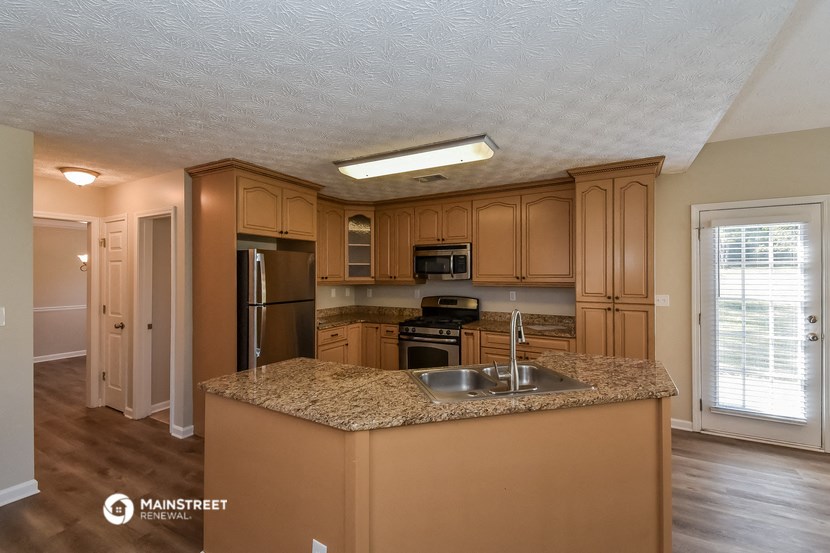 the kitchen with granite countertops and stainless steel appliances