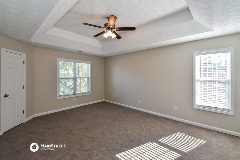 the master bedroom is spacious and has a ceiling fan