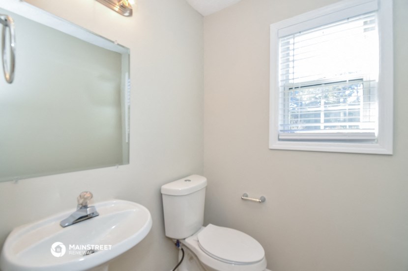 a bathroom with a mirror and a toilet and a sink