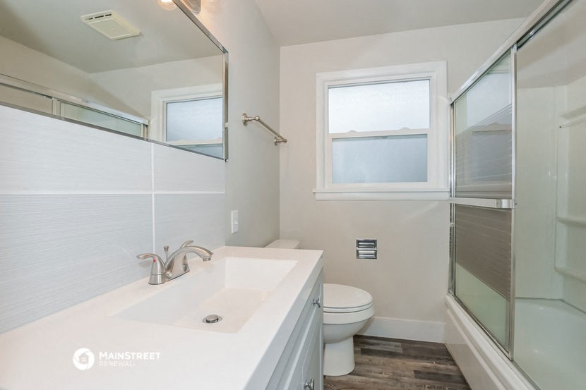 a bathroom with a sink toilet and a shower