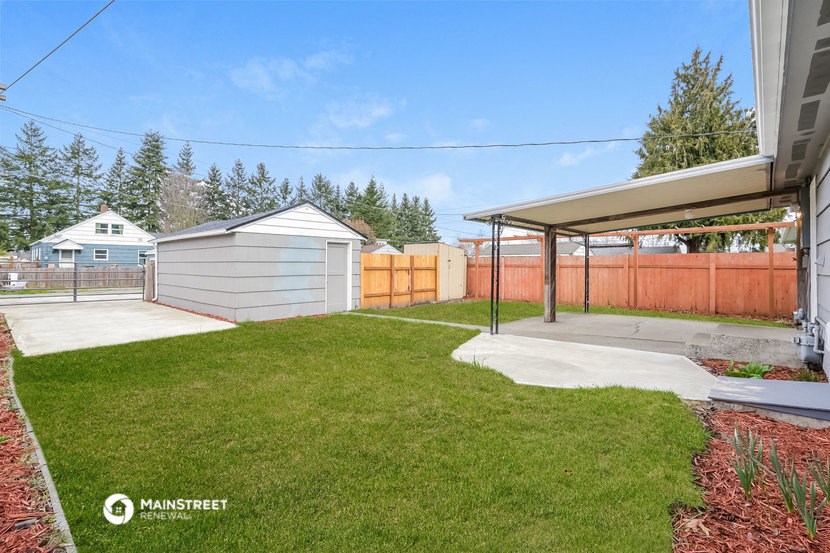 the backyard of a house with a yard and a garage