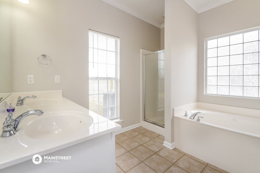 a bathroom with a sink and a tub and a shower