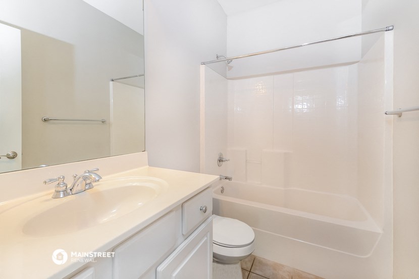 a bathroom with a sink and a shower and a toilet