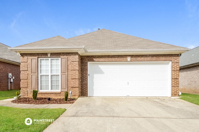 a brick house with a white garage door