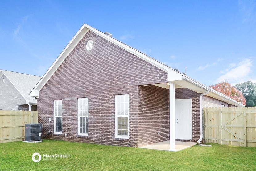 the outside of a brick house with a white door