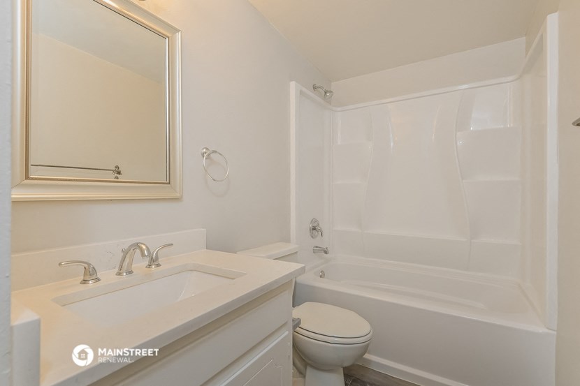 a bathroom with a sink toilet and a tub