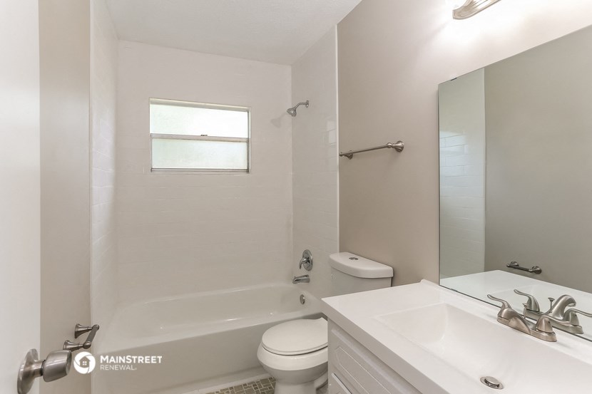 a bathroom with a sink toilet and a bath tub
