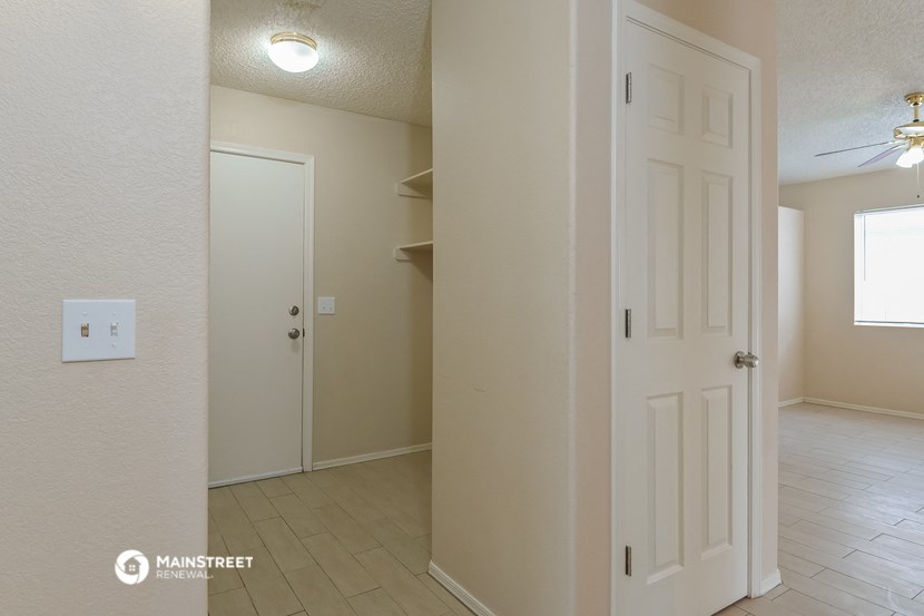 a bedroom with a closet and a door to a bathroom