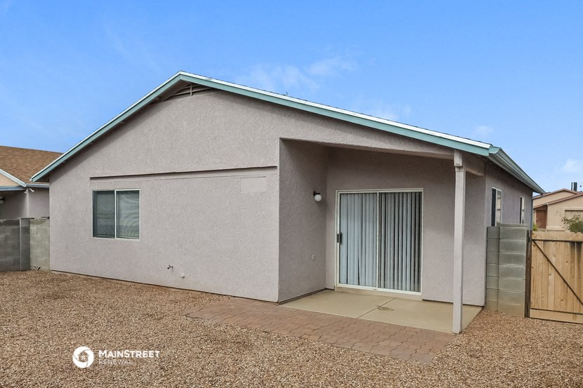 a small house with a garage and a sliding glass door