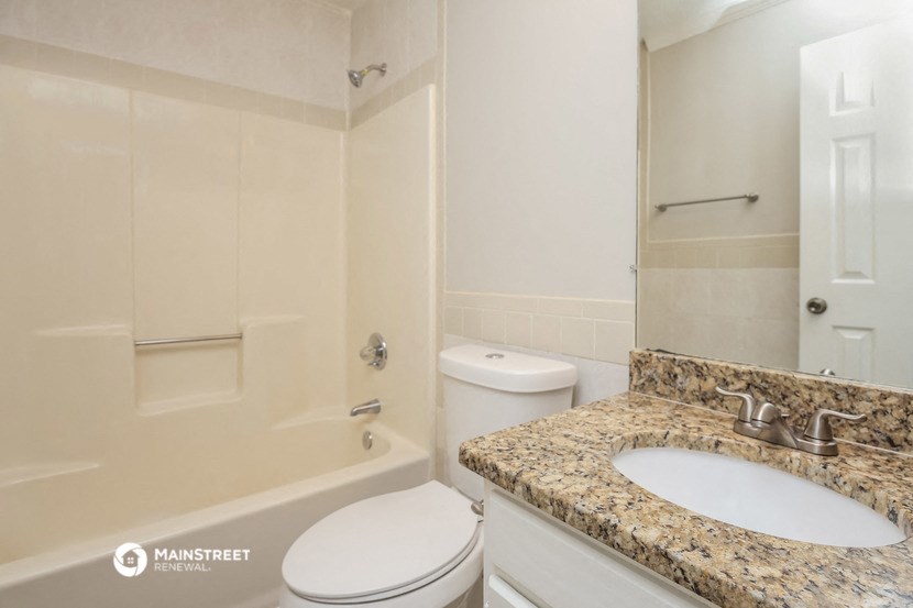 a bathroom with a sink and a toilet and a shower