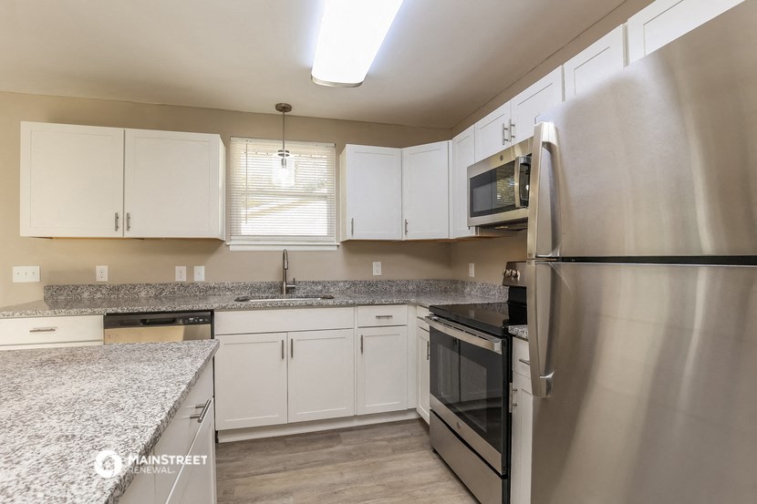 a kitchen with granite counter tops and stainless steel appliances