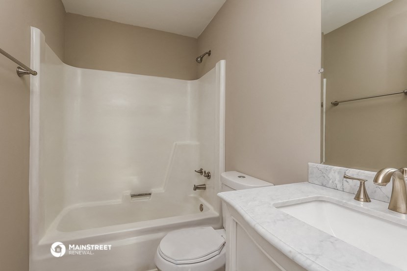 a bathroom with a sink toilet and a bath tub