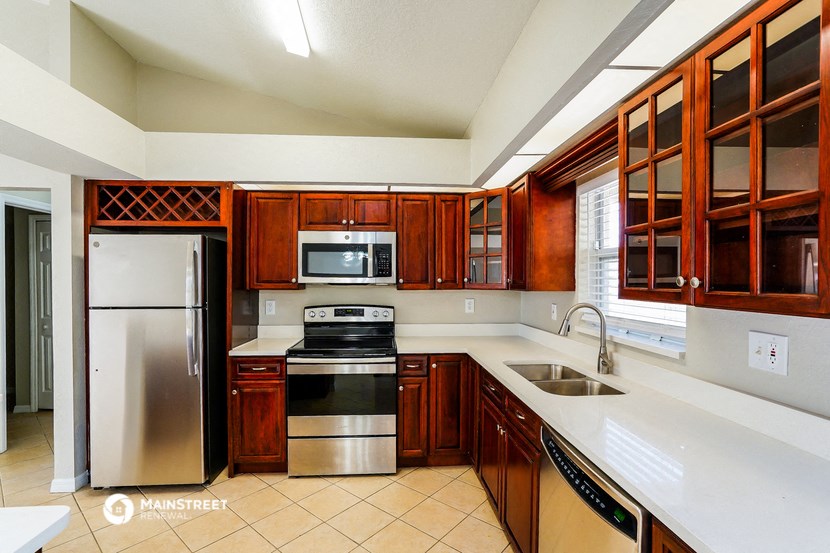 a kitchen with wooden cabinets and stainless steel appliances