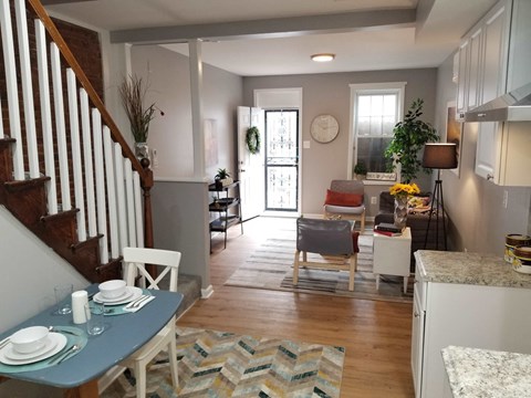 a living room and dining room with a table and chairs