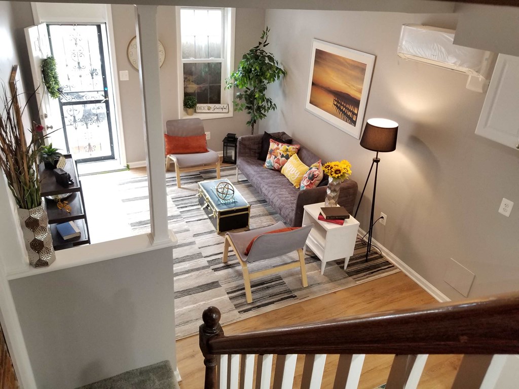 a living room with a couch and chairs in a small room