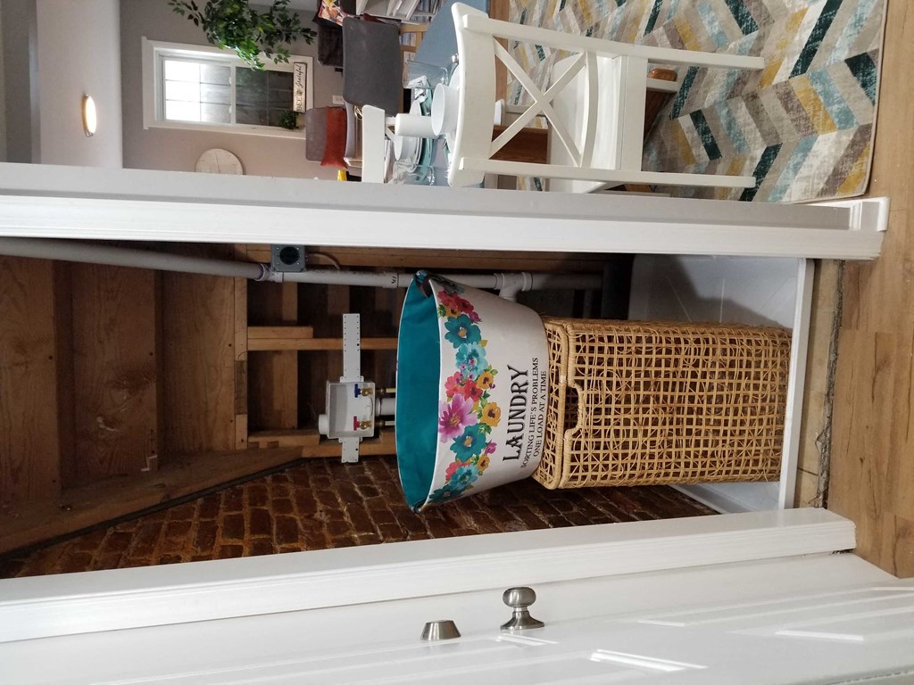 a coffee cup hanging on a shelf in a kitchen