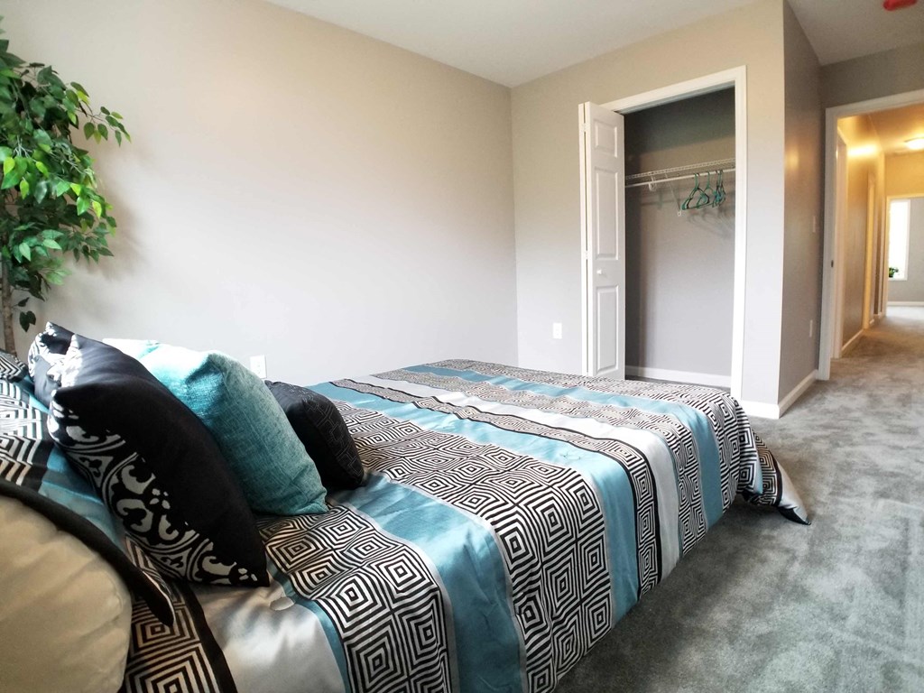 a bedroom with a large bed and a walk in closet