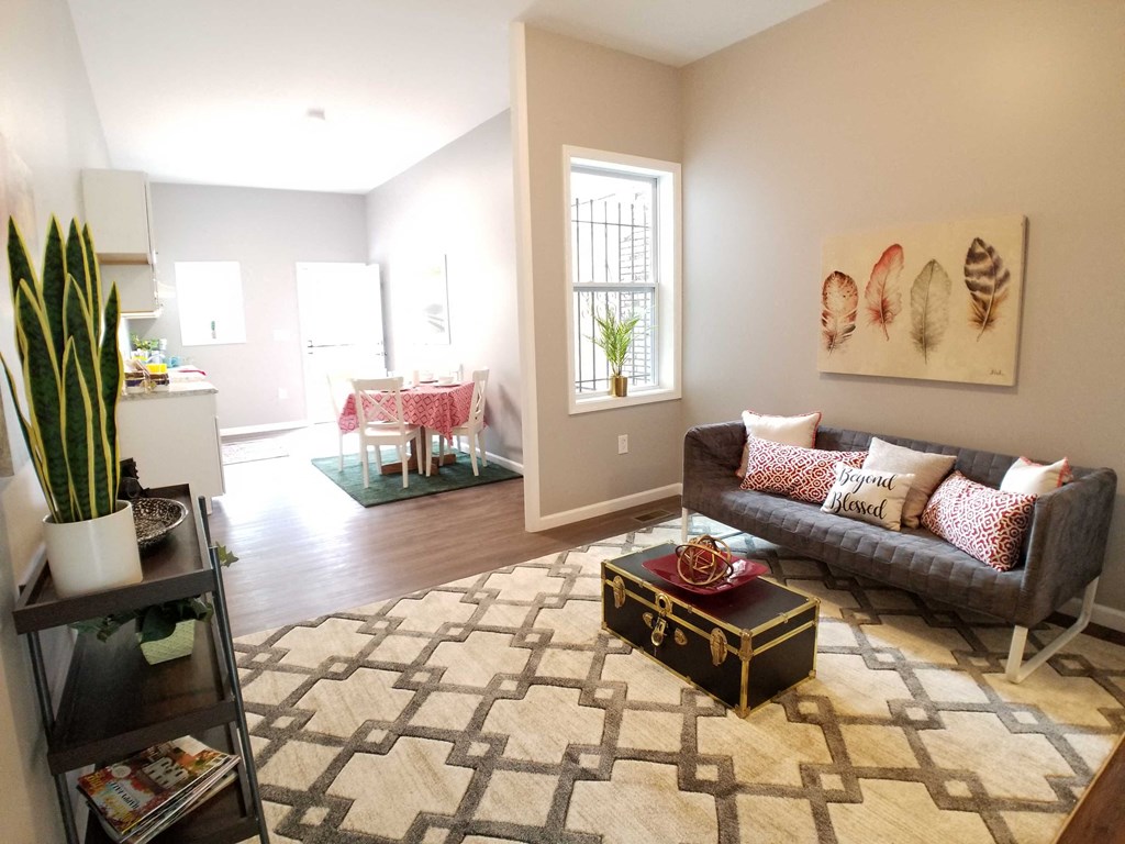 a living room with a couch and a rug