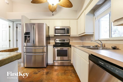 a kitchen with stainless steel appliances and white cabinets