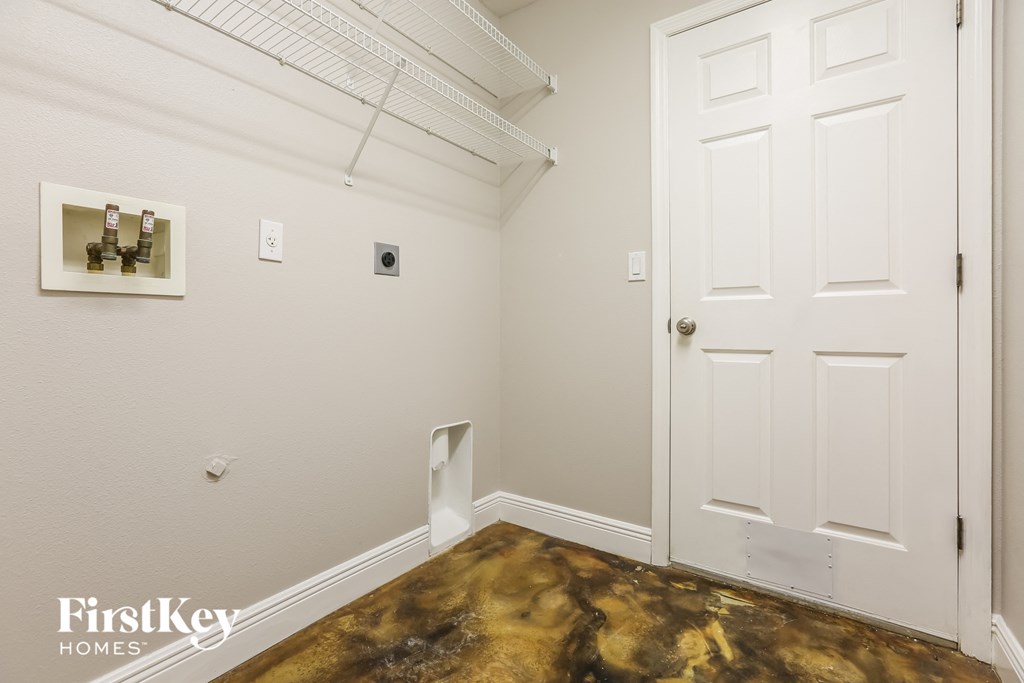 a room with a white door and a white wall with a closet and a door