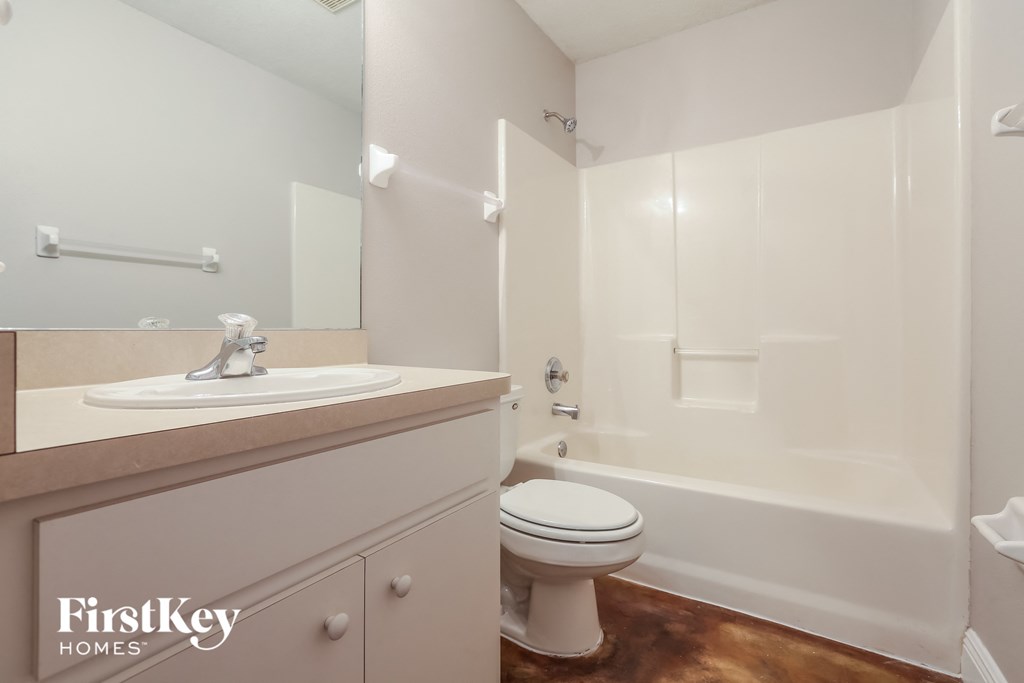 a white bathroom with a sink toilet and shower