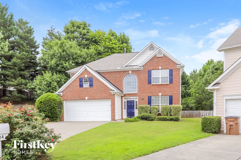a brick house with a yard and a blue door