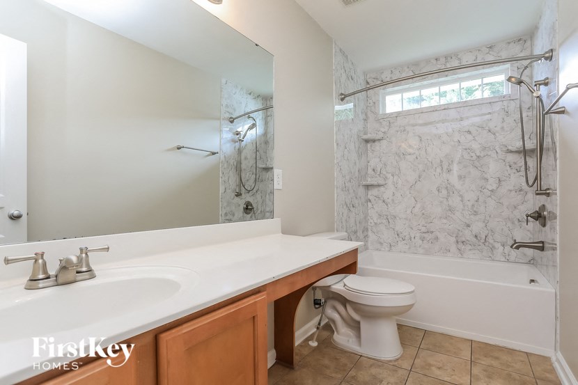 a bathroom with a sink toilet and a shower