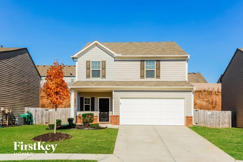 a house with a white garage door and a lawn