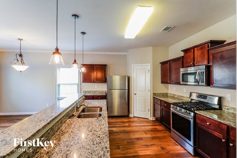 a kitchen with granite counter tops and stainless steel appliances