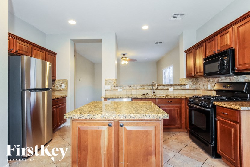A kitchen with granite countertops and stainless steel appliances.