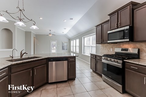 A kitchen with brown cabinets and a stainless steel dishwasher.
