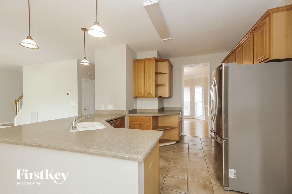 a kitchen with a sink and a refrigerator
