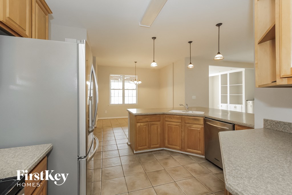 a kitchen with wood cabinets and stainless steel appliances