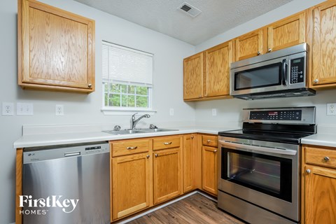 A kitchen with wooden cabinets and stainless steel appliances.